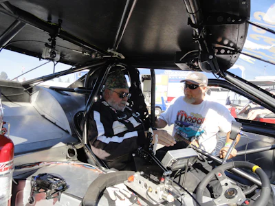 I don't always work on asphalt plants. This is my mechanic/welder Richard helping me get strapped into the seat of our 1991 Ford Thunderbird we built in our shops. This car has a 1,400-hp Ford motor and runs 7.7 seconds @ 185 mph in the 1/4 mile. We use this and other race cars we build to demonstrate the welding skills, electrical and mechanical skills we possess here at CMC. If we can build this kind of 'high quality and dangerous' equipment, asphalt plants are easy! We also take our clients to races with us and have them help on the cars for the weekend.