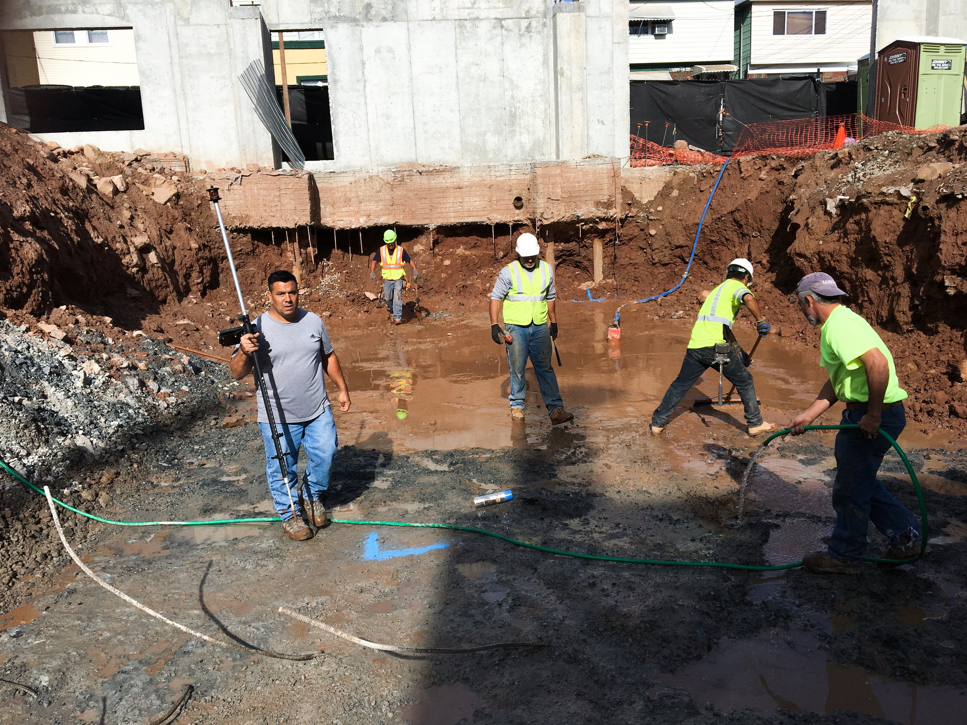 Workers can accurately locate points regardless of site conditions such as in excavations, sloped areas, or in mud. The instrument can be located at a safe distance from construction traffic and automatically compensate. The worker shown here is carrying the rod with a computer tablet mounted on it.
