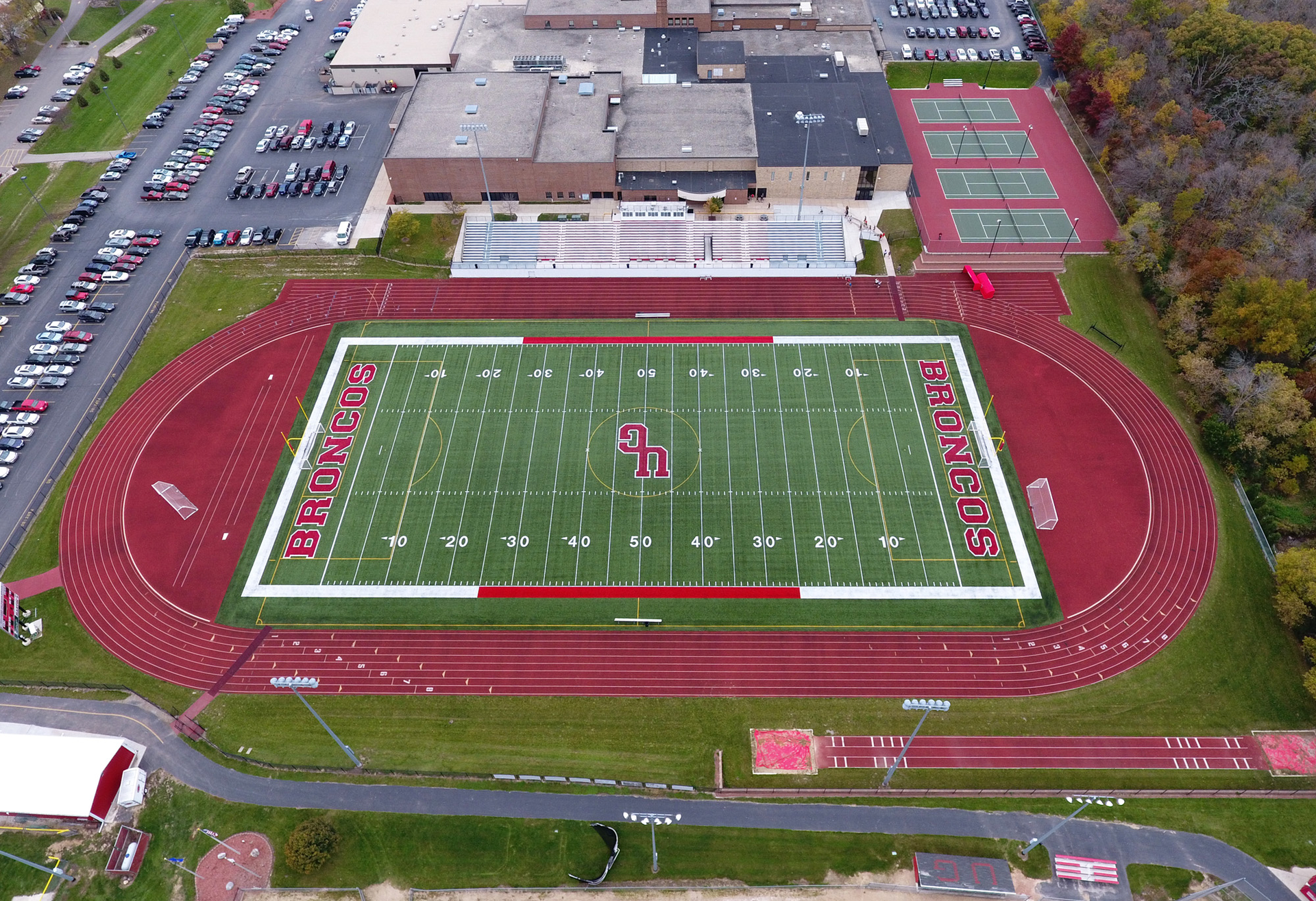 Approximately 1,800 tons of E mix asphalt was placed in two layers. ACI laid the base course, placed tack and then placed the surface course of the running track.
