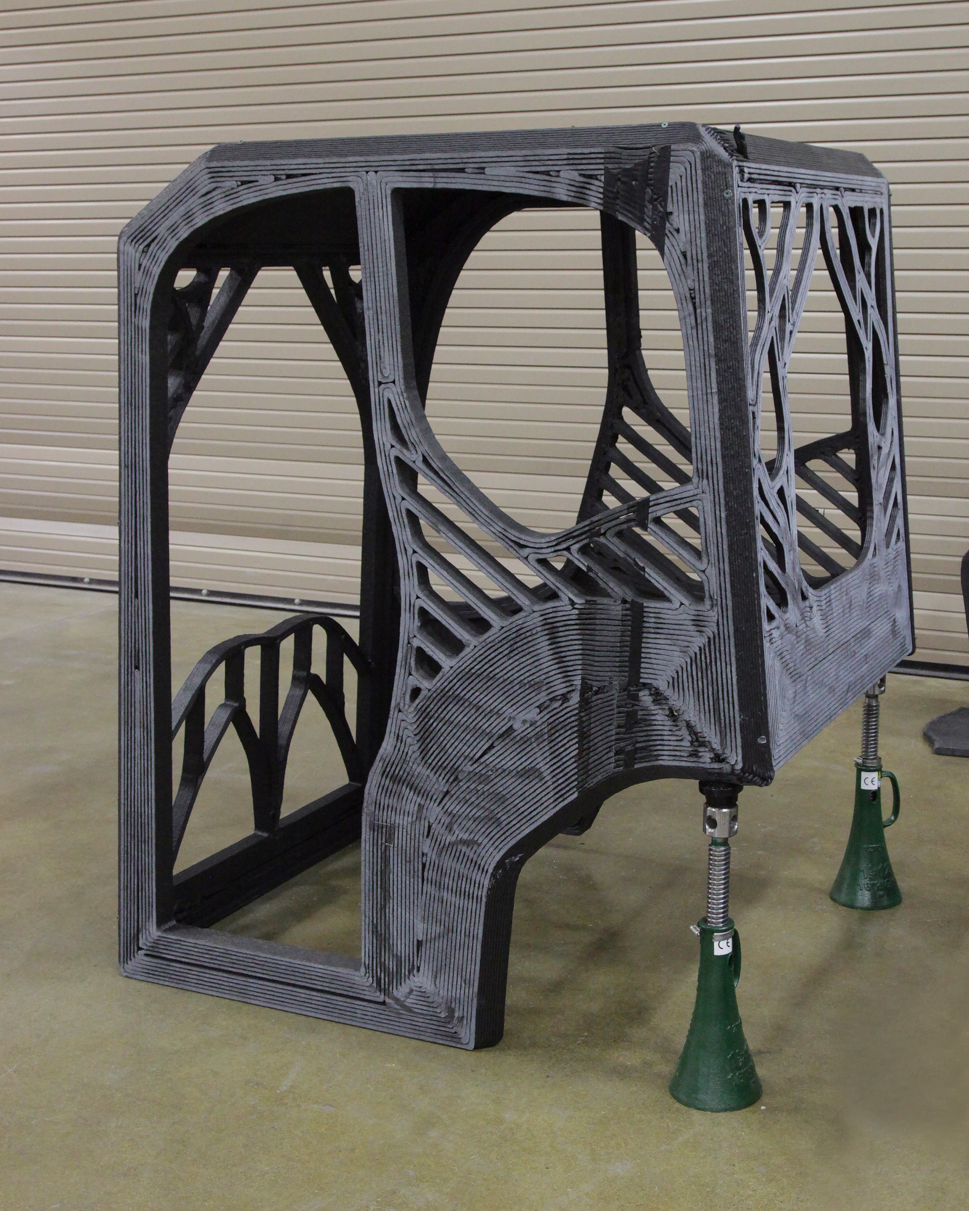 The completed 3D printed excavator cab was printed with an additive manufacturing machine that used carbon fiber-reinforced acrylonitrile butadiene styrene (ABS) plastic.