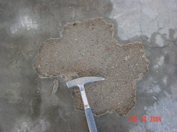Surface delaminations are separations of the top surface from the underlying concrete.