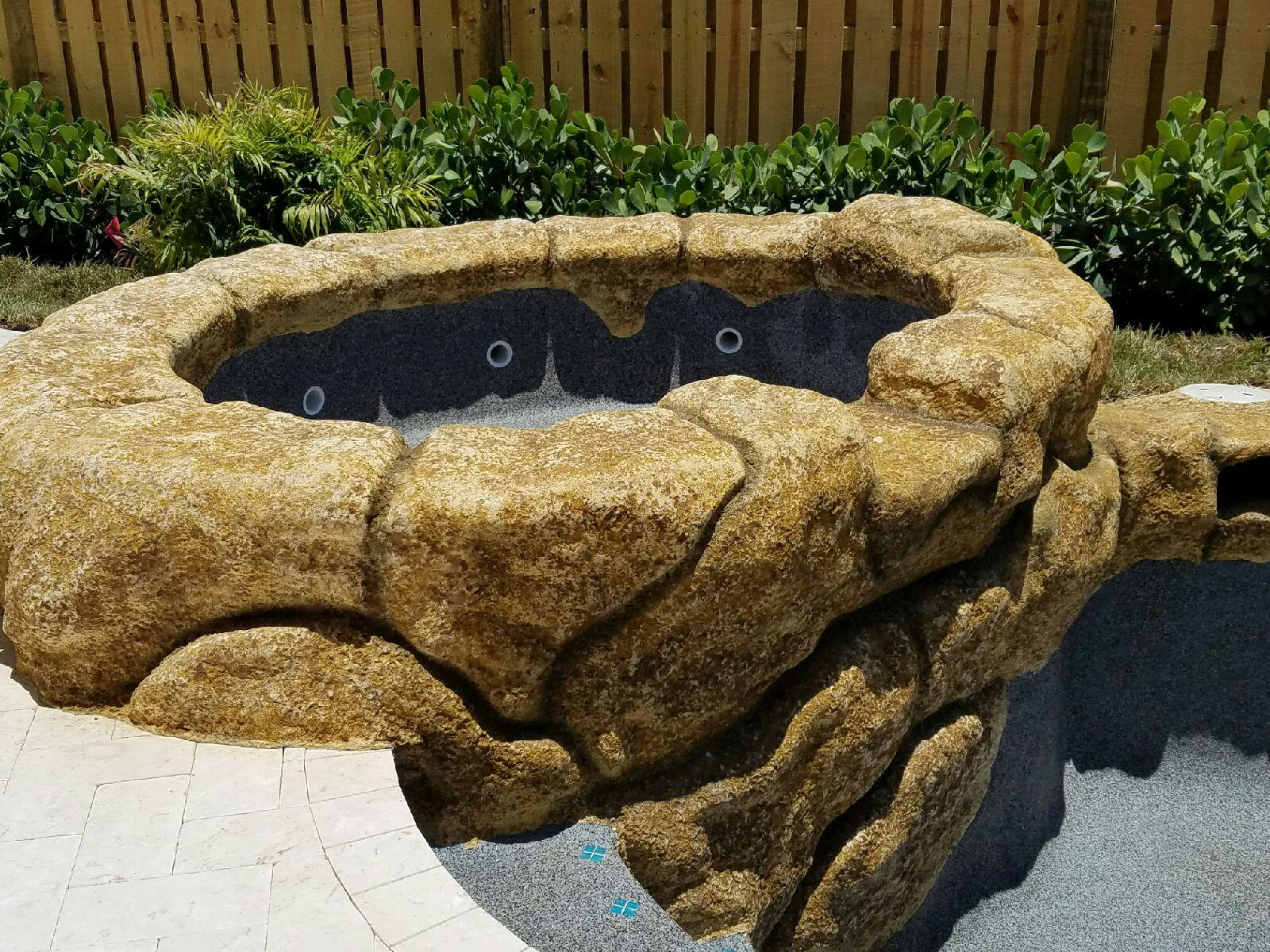 The rock waterfall pictured here was created using a concrete squeeze pump, which was the ideal solution for Pool Crafters to preserve the detailed process of rock carving.