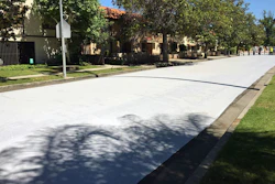 Workers apply a cool pavement coating to a street Saturday May 20, 2017 in Canoga Park. The coating is designed to reduce temperatures on the the surface of streets during Southern California heat waves.