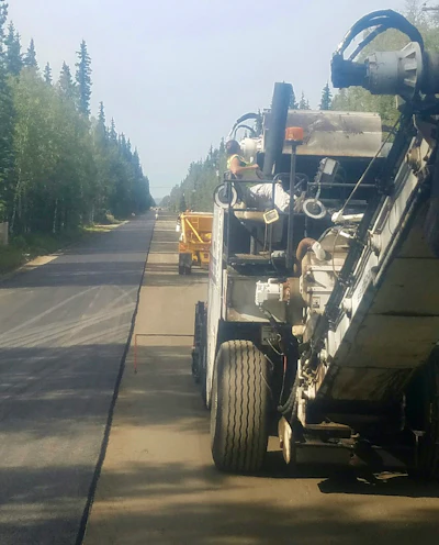 When it came time to pave the 11-ft.-wide road with 4-ft. shoulders on each side Exclusive Paving paved one lane in one direction from start to finish, then turned around and paved the same distance in the other direction, completing the paving with only one seam down the middle.
