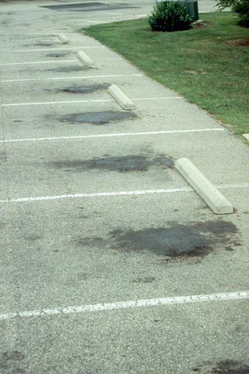 If the asphalt has not been sealed, the oil will start to dissolve the asphalt binder in the pavement leading to pitting. When pitting occurs, the problem is compounded by allowing water to wash other oil and chemicals into the pitted area, further deteriorating the pavement.