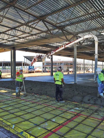 The Z-Fold boom of the 43Z-meter and a shorter end hose are shown placing concrete under low ceilings.