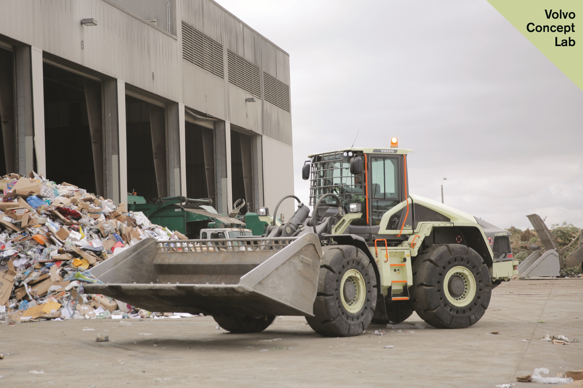 Volvo CE's LX1 prototype electric hybrid wheel loader at Waste Management's Moreno Valley Transfer Station. The LX1 is a series hybrid, which puts an electric motor at each wheel and replaces an equivalent-sized conventional loader's 13L engine with a 3.6L diesel, on board strictly to run the loader's generator. Volvo says 98% of the components on the LX1 are new.