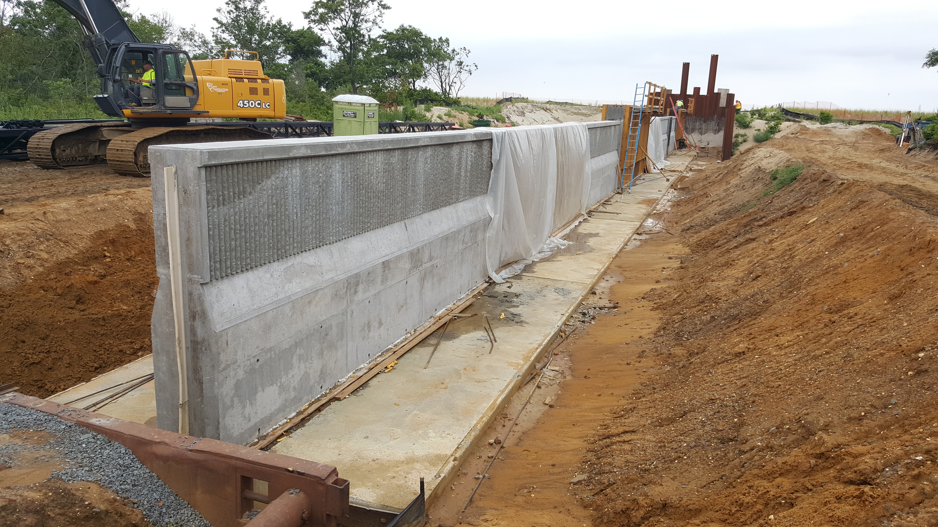 A concrete flood wall is being constructed to help reduce flooding as part of the Port Monmouth Flood Risk Management Project in Port Monmouth, New Jersey.