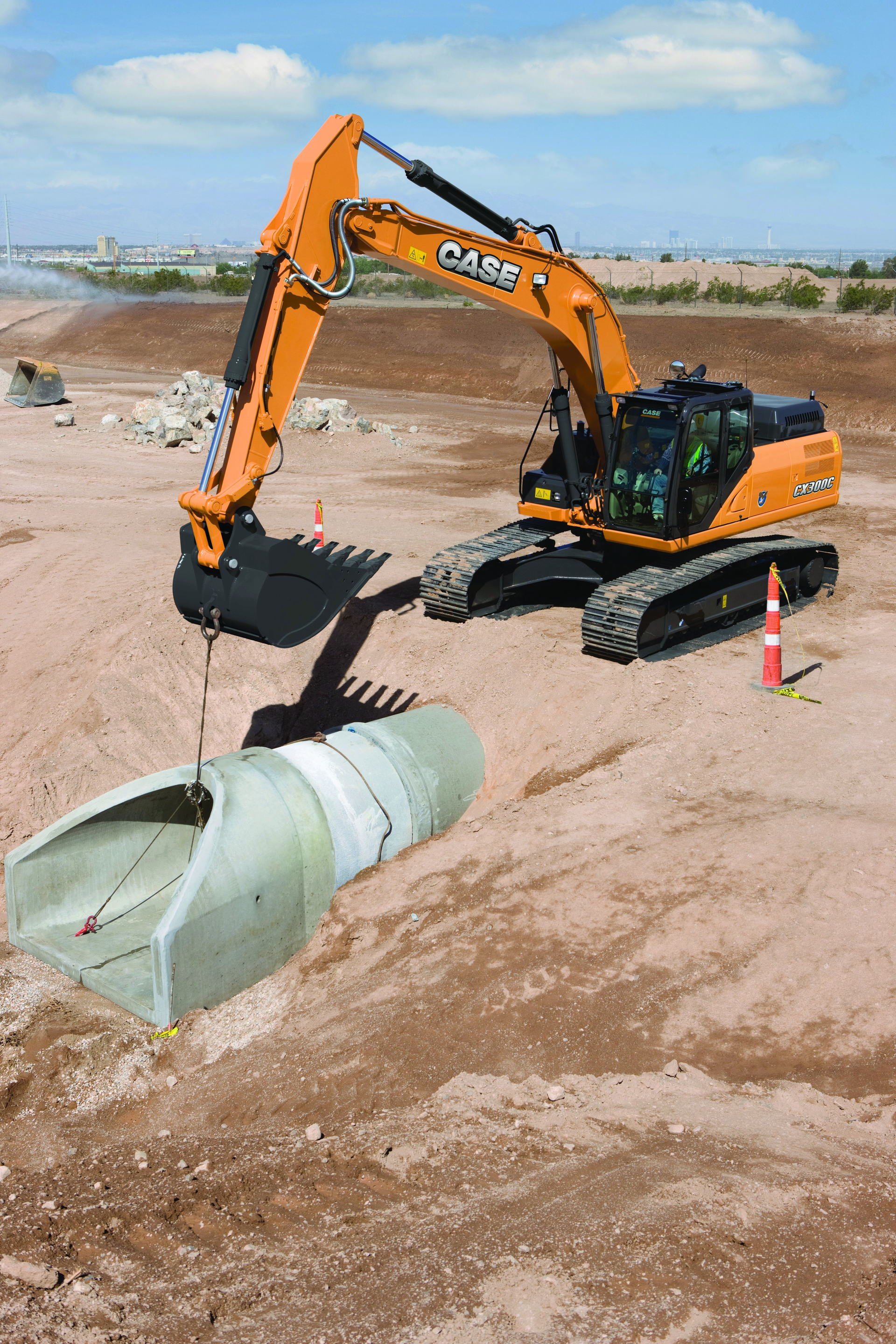 The operator should be be able to maintain visibility into the hole or trench as the load is being lowered. Position the machine so the lowering is done over the end of the machine and not over the side.