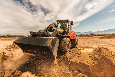 Even paint schemes can help with visibility. The lower contrast of Doosan's charcoal lift arm with the background allows the eyes to shift focus to the background, which provides the optical perception of improved visibility to the work area.