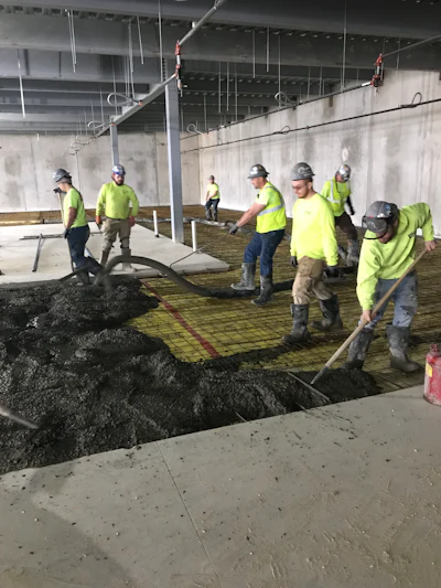 Figure 3: Placing concrete utilizing concrete pump and downline.
