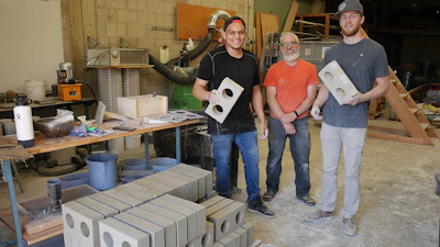 Washington State University team Jose Becerra, David Drake and Jacob Sauer (left to right) display brick they have made from drywall construction waste.