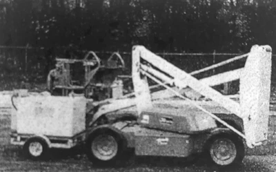 An early attempt at hybrid technology: a boom lift with a generator on a trailer.