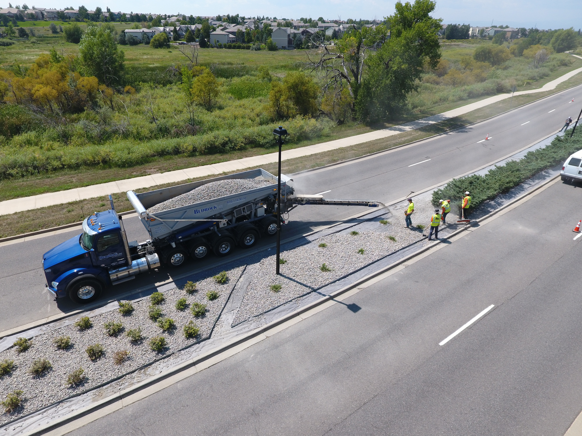 In typical stone applications, a Stone Slinger system can accurately place material up to 100 ft. from the truck. The throwing distance will be less for light-density “fluffy” materials. A shorter conveyor is also available for close-in applications such as roadway and sidewalk reconstruction in older, heart of city work.
