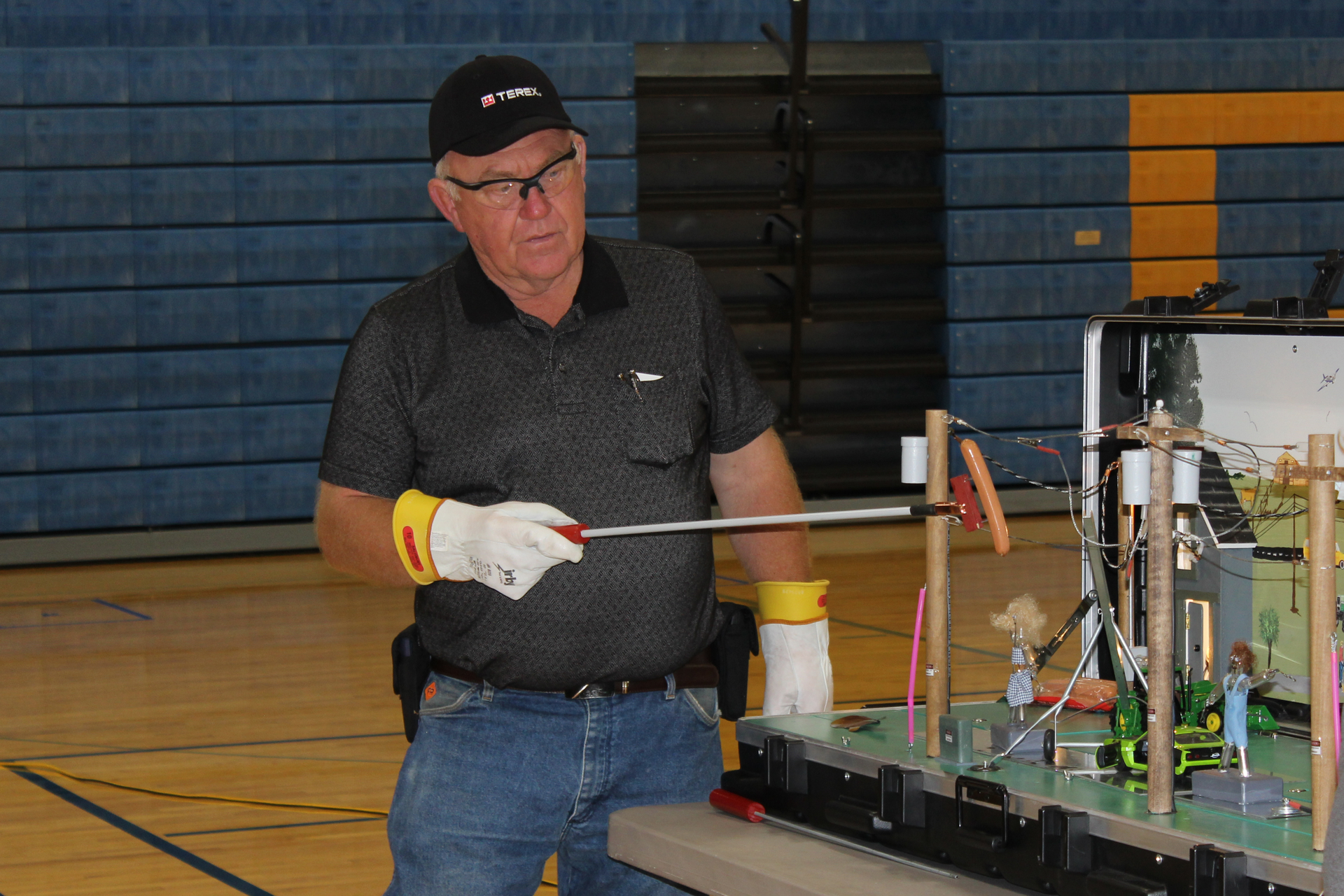 Roger Crom, retired lineman and Terex Utilities safety consultant, demonstrates how electricity in Safety Town works. The hot dog is used to mimic what happens in the human body when exposed to electricity.