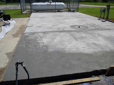 One of Thomas Werline's most recent projects was to renew an uneven, heavily soiled and unattractive concrete deck utilized for a large waste container holding area at a Central Florida school.