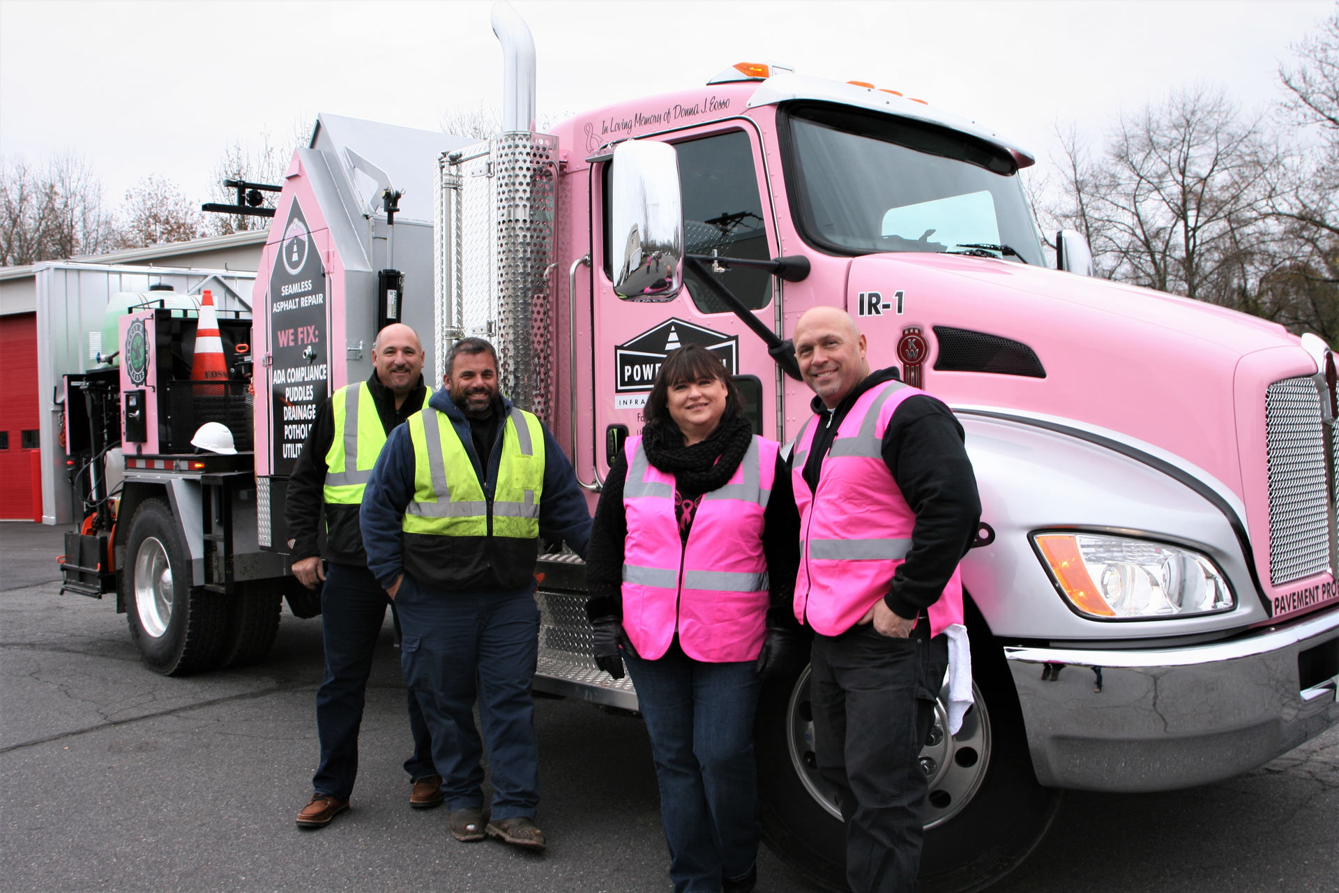 The Eosso family and the pink-branded infrared truck (from left) Tom Eosso, Eosso vice president and chief estimator; Gary Eosso, Eosso president and project manager; Kim Mazzoni, Power Patch Infrared Specialists president; and Anthony Eosso, Eosso trainer and estimator.
