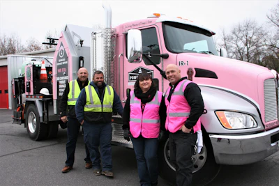 The Eosso family and the pink-branded infrared truck (from left) Tom Eosso, Eosso vice president and chief estimator; Gary Eosso, Eosso president and project manager; Kim Mazzoni, Power Patch Infrared Specialists president; and Anthony Eosso, Eosso trainer and estimator.