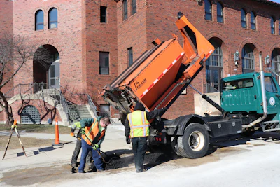 The Public Works Department team using its Falcon hot box and recycler to make repairs outside New Trier High School in Winnetka, IL. Built to be slid into the bed of a truck, the Falcon unit is available in 2-, 3-, 4-, 5-, 6-, 8- or 10-ton capacities.