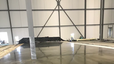 Columns shrink wrapped and end wall protected during concrete placement.