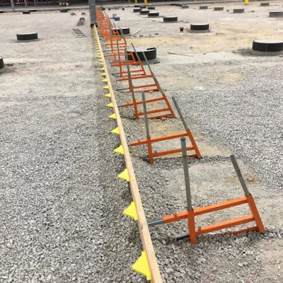 Slab edge forming with dowel pocket formers installed.