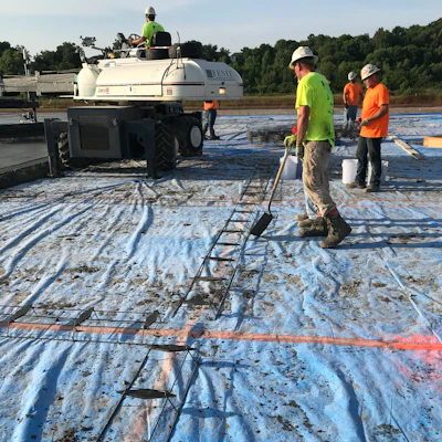 Plate dowel baskets being installed during placement.