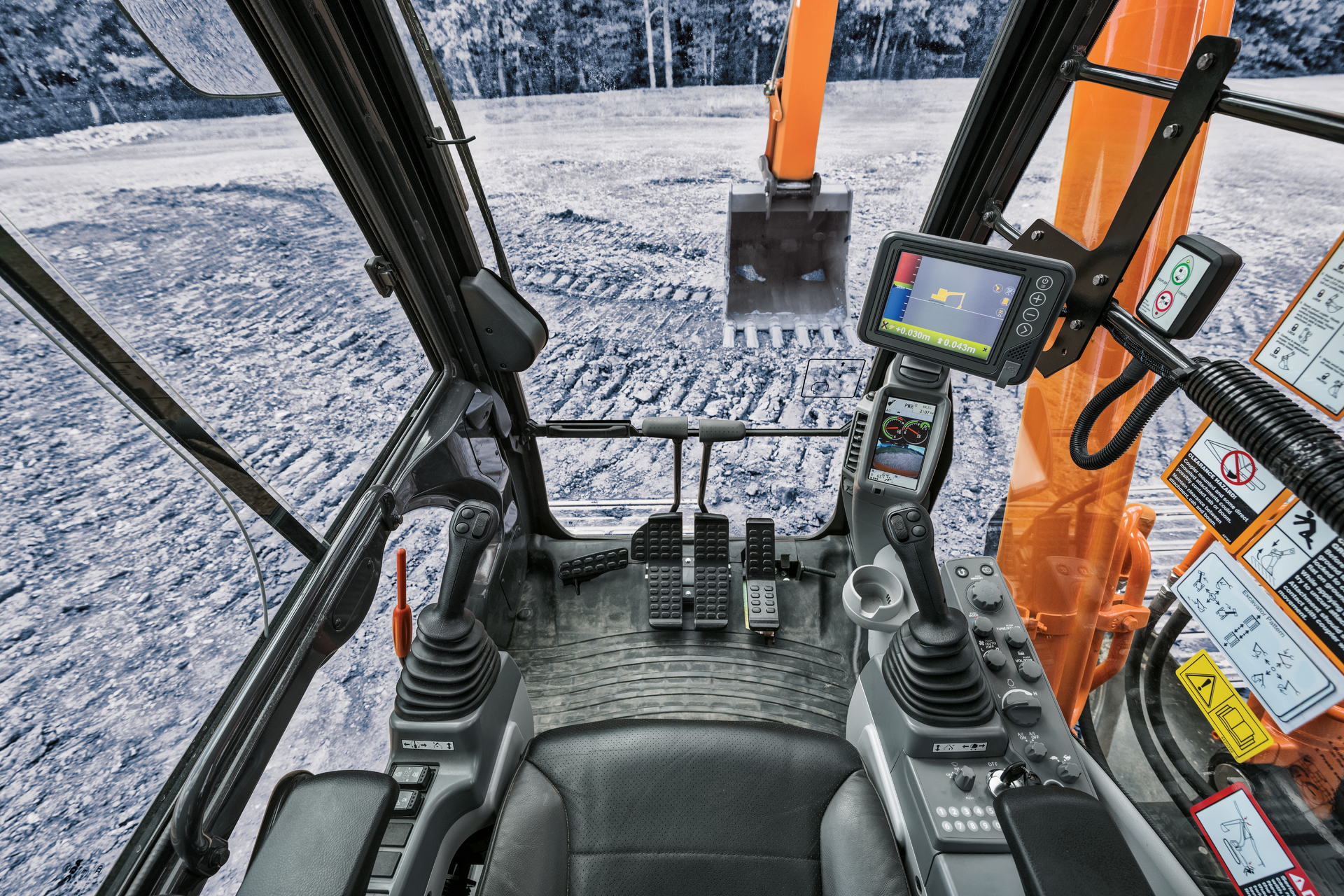 Real-time grade indicator allows operators to manage grade without leaving the cab, and reduces need for grade checkers or grade stakes. Controls integrated into the joysticks enables fingertip control.
