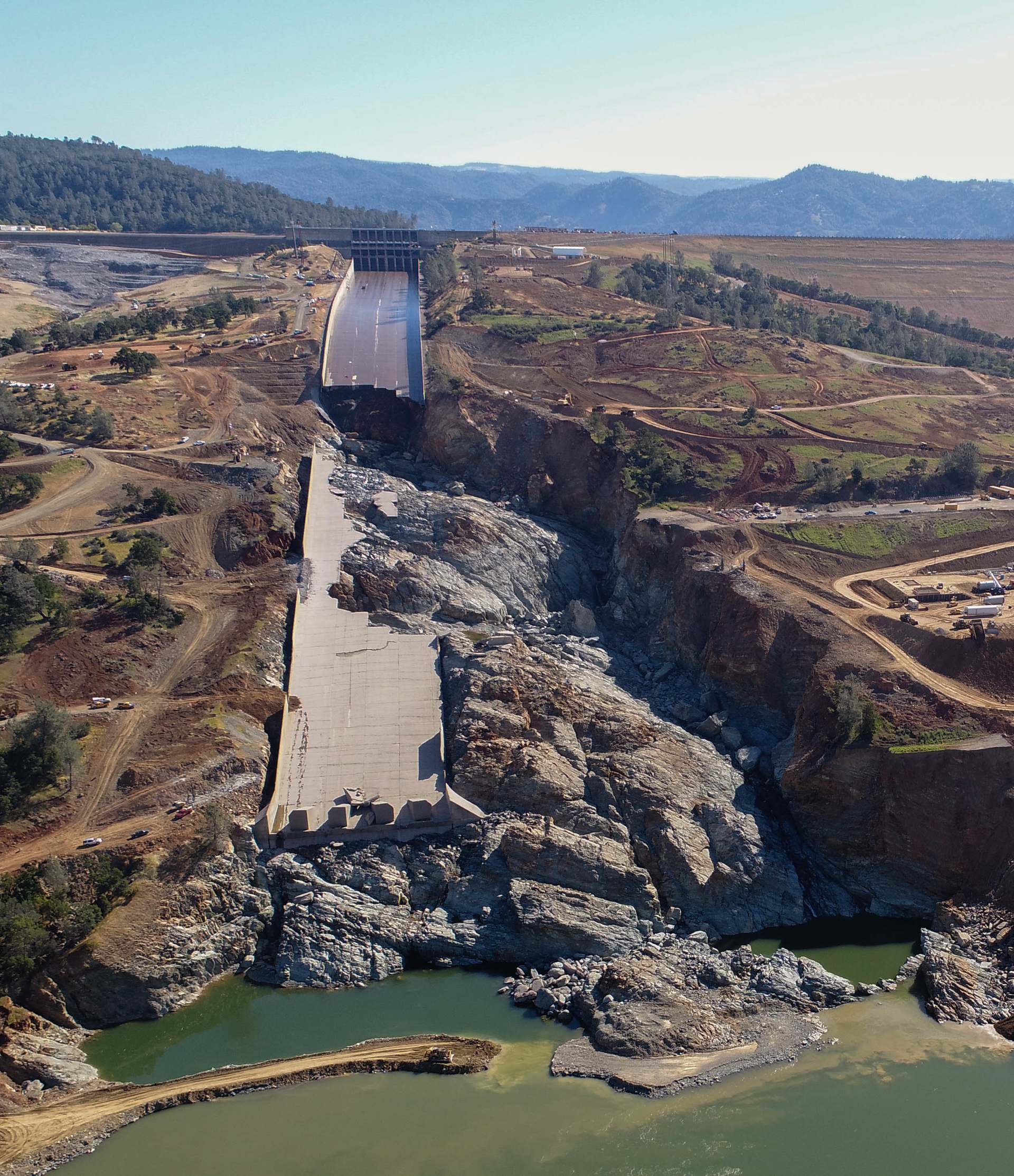 In February of 2017 the California Department of Water Resources opened the spillway on the Oroville Dam to reduce the flood water level of the lake. Rushing water destroyed the center portion of the spillway floor, washed away a section of the spillway wall, and created a 150 deep canyon in the spillway. With the dam at risk in the event of another flood an emergency construction project commenced to replace the spillway and the emergency spillway beside it. Photo Credit: DWR