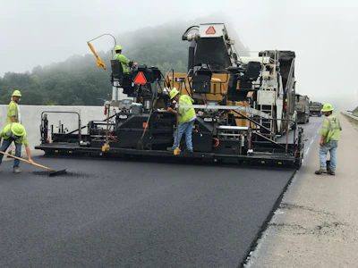 99% of the mix was placed with a Caterpillar AP1055F paver with the specialized high density screed and most of the rolling was done with Caterpillar CB54 XW rollers. The intermediate and surface mixes were installed with the use of a Roadtec SB-2500 Shuttle Buggy to prevent segregation. The company also rented a Vögele Super 700-3i paver to pave the 4-ft. shoulders on the project.