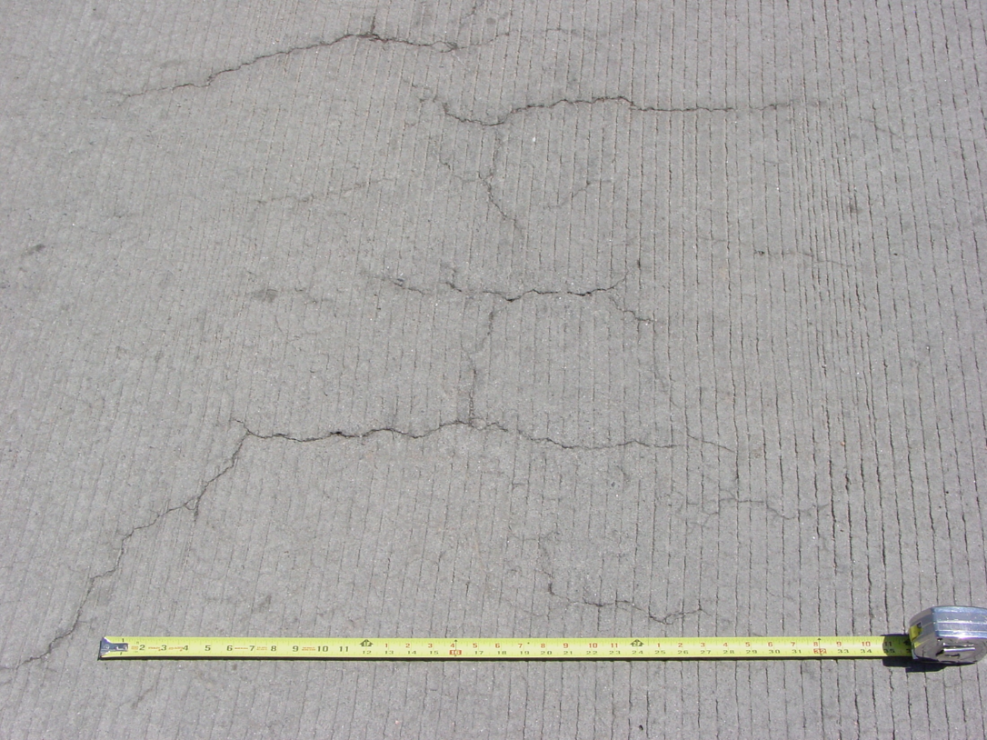 Occurring in both random and parallel patterns, plastic shrinkage cracks are discontinuous, relatively short and typically fairly shallow. Occasionally they can become full-depth cracks. Parallel cracks are typically spaced between a few inches to several feet apart and many times are oriented perpendicular to the prevailing wind direction. Cracks widths at the surface can be fairly wide (as much as 1/8 in.) but rapidly diminish with depth.