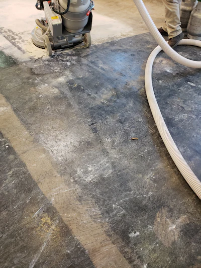 Once all floor coverings, adhesives and epoxies were removed, minor repairs were made, and the floor was ready for multi-step grinding.