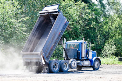 In addition to problems with the dump and the bed, build-up that remains in the truck bed will cool and cure. If portions break off during the following haul, this partially cooled and set mix is not consistent with the new load. An inconsistent mix could lead to sections of pavement with varying properties.