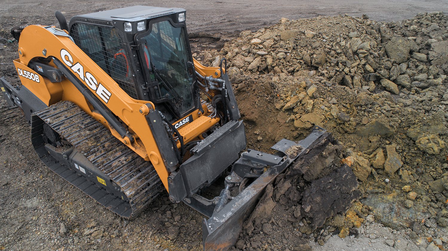 Case's new DL550B dozer/loader distinguishes itself from compact track loaders with a frame-mounted dozer, steel tracks and structural weight designed for heavy dozing work.