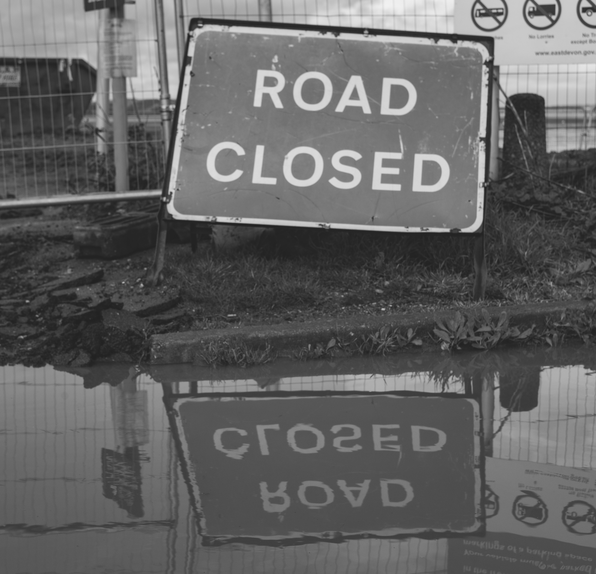 Grayscale Photo Of Road Closed 3907990