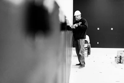 Man In Black Jacket And Pants Standing In Front Of Wall 3849350
