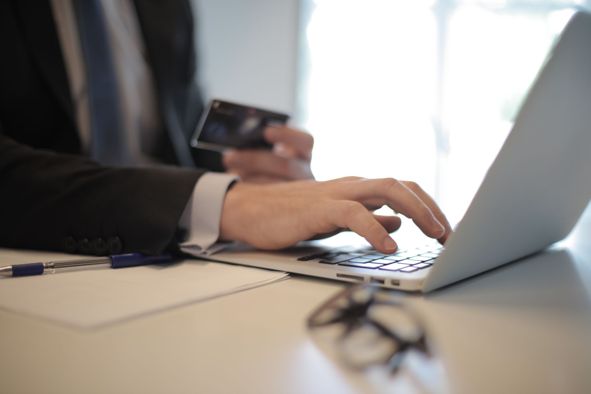 Person In Black Suit Typing On A Computer 3760081
