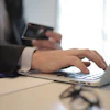 Person In Black Suit Typing On A Computer 3760081