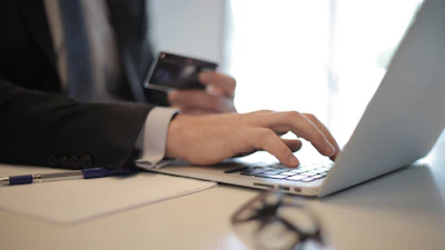 Person In Black Suit Typing On A Computer 3760081