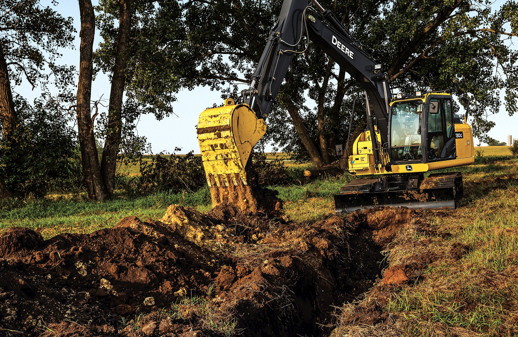 If you have to dig a trench while on a slope, be aware of the boom and arm position. When swinging, bring the boom and arm in fairly close to the machine. When coming out of the hole, bring the mast in toward the machine so the swing torque will allow the machine to swing.