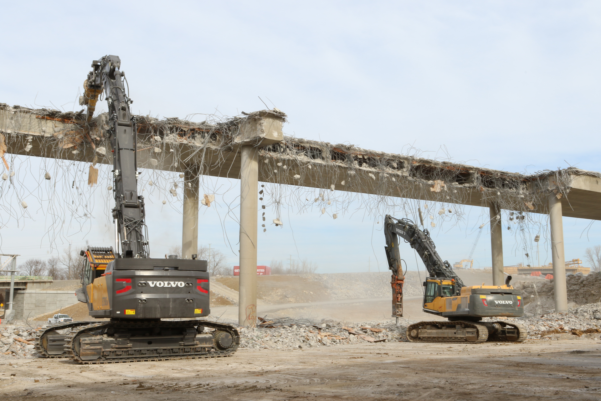 Greg Bair Track Hoe Services Inc. used a Volvo EC750E HR and a EC480D high-reach demolition excavator working side by side to demolish the two bridges in a very tight time frame.