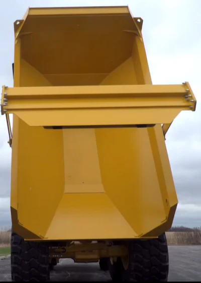 The redesigned John Deere ADT dump box incorporates a straight flat section to the floor, which makes it very easy to clean out with an excavator