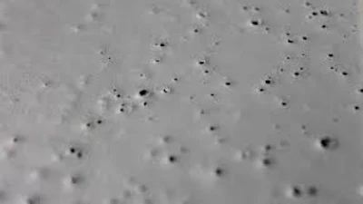 Coating pinholes in a concrete floor.