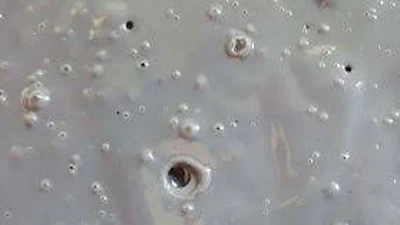 Coating pinholes in a concrete floor.