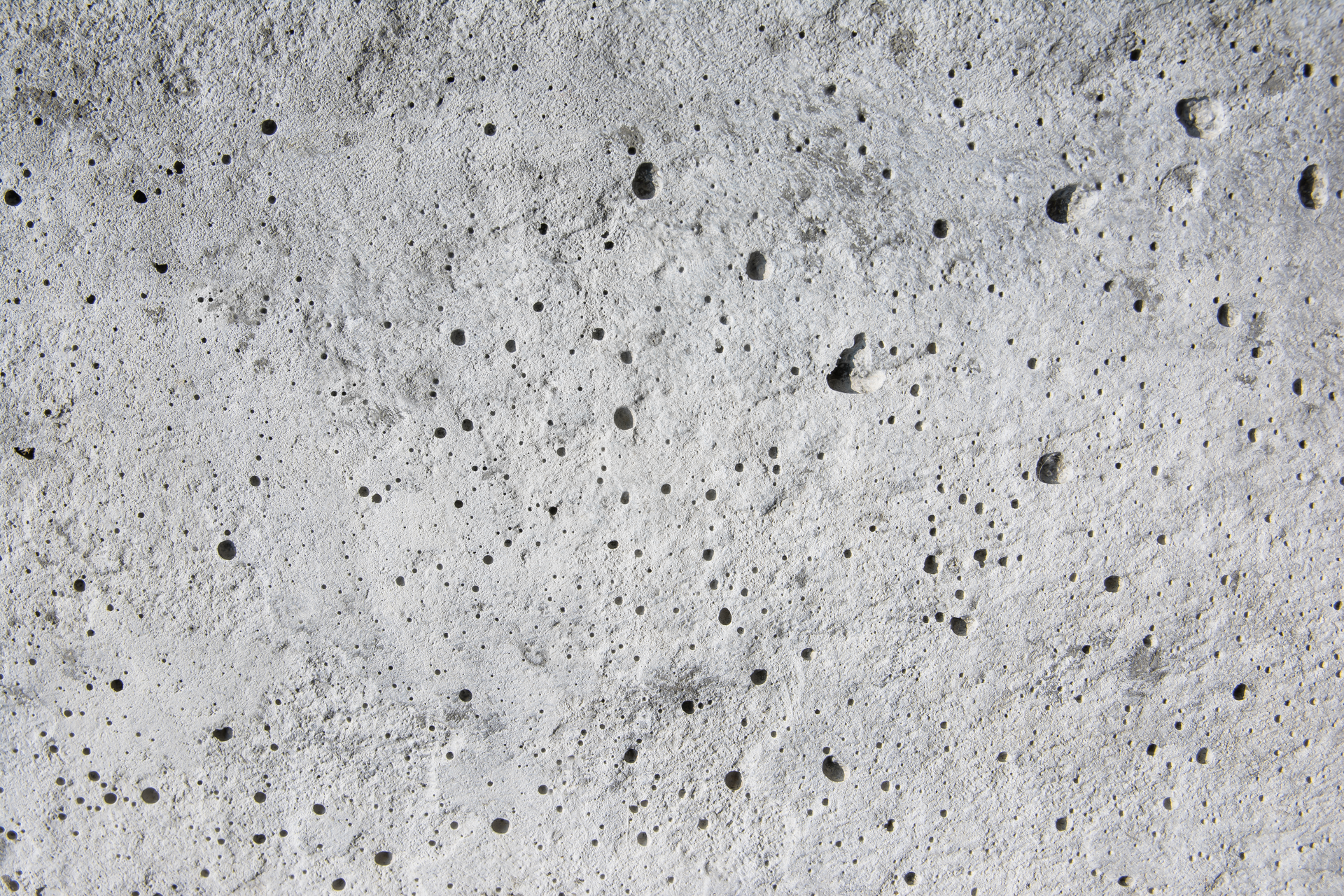 Coating voids and pores in a concrete floor.