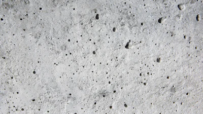 Coating voids and pores in a concrete floor.