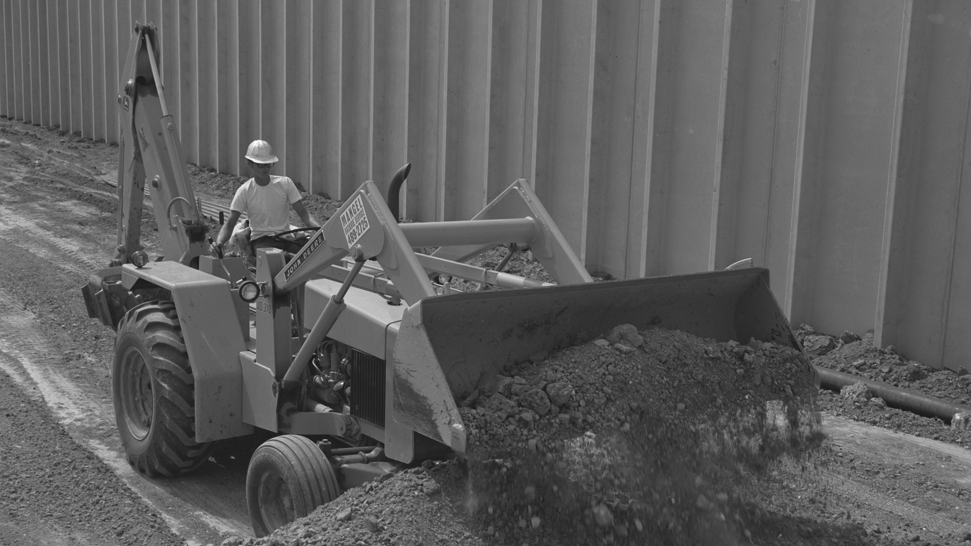 John Deere first started backhoe-loader production with the introduction of the JD310 model in 1971.