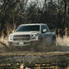 Some benefits offered by a lifted truck equipped with larger tires include increased visibility, along with needed ground clearance, both of which reduce risk of damage to the undercarriage.
