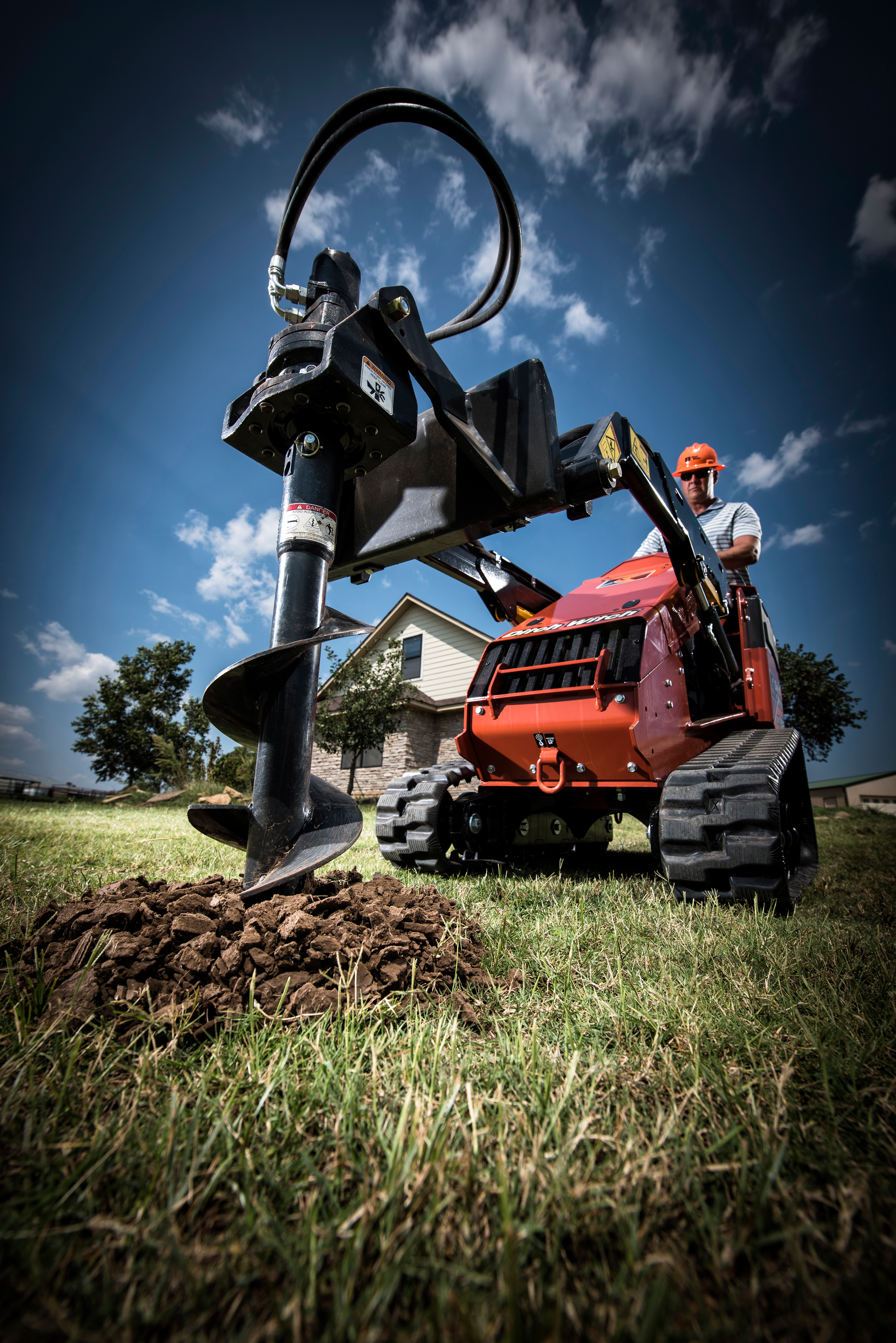 Stand-on skid steer attachments like augers help landscaping crews make efficient work even with a lean team.