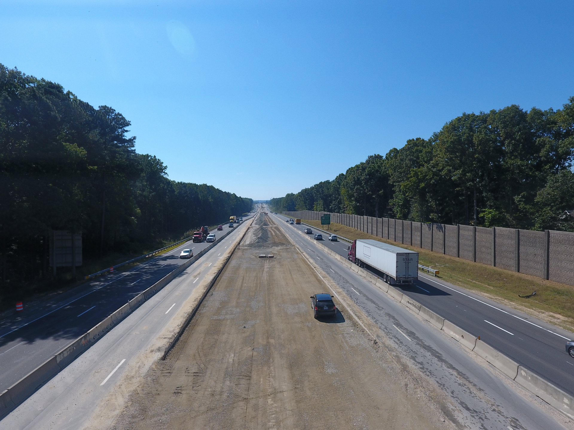 Crews have utilized a temporary access ramp beside the Garner plant that runs from a closed bridge to help bypass traffic and haul asphalt right down into the median. A temporary road built adjacent to the plant provides access to the outside shoulder in the westbound direction. This system will save the team from having to haul approximately 24,500 loads of asphalt in traffic during the project.