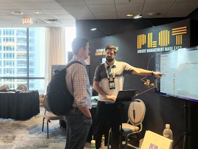 Jobsite logistics startup Plot exhibits at Advancing Construction Technology 2022. Here, Founder and CEO Chris Callen connects with an attendee.